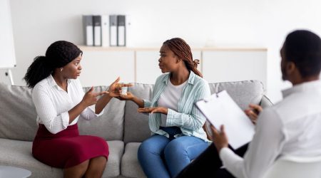 african-american-lesbian-couple-having-consultation-with-psychologist-at-office.jpg